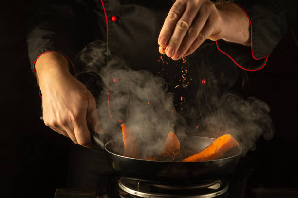 istock In a warm kitchen, skilled hands sprinkle aromatic spices into a pan of brightly colored vegetables. The rising steam and rich colors create a tantalizing atmosphere of culinary creativity 2193299673