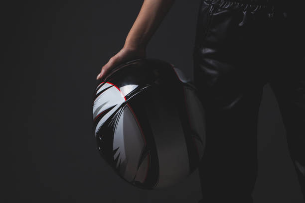 Portrait of a man putting on his helmet and getting ready to race in the go-carts