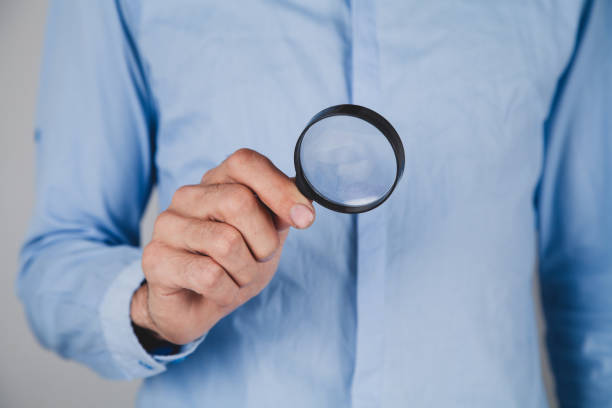 istock businessman magnifying glass in hands. 2193301600