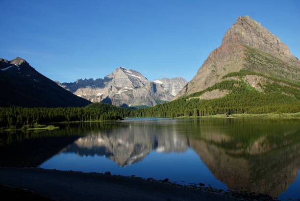 istock Mountains reflecting in Glacier Lake 2193303015