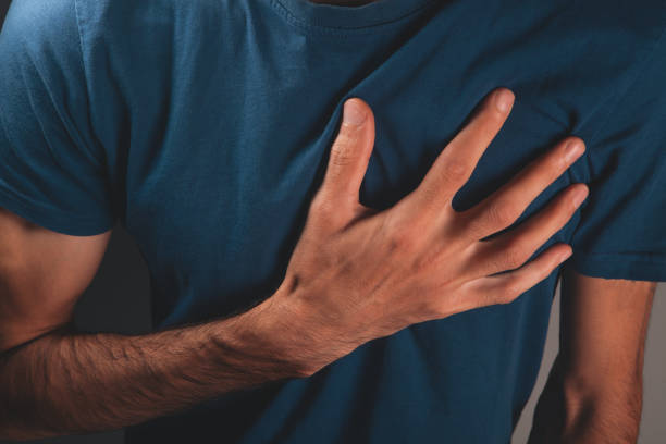 istock man in white sweater with a heart on his hand 2193304152