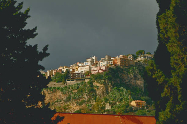 Park Giardini della villa comunale in Taormina, Sicily, Italy stock photo with a view of beautiful hills behind Taormina