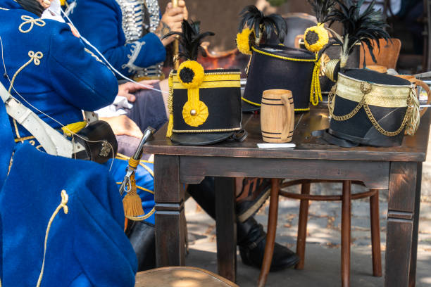 Hungarian Hussar Hats on Table with Traditional Blue Uniforms