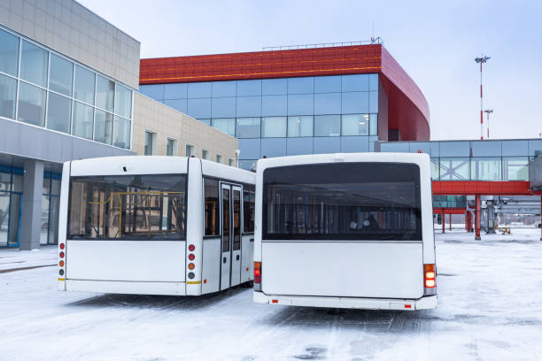 istock Two airport shuttle buses at the winter next to the terminal 2193306860