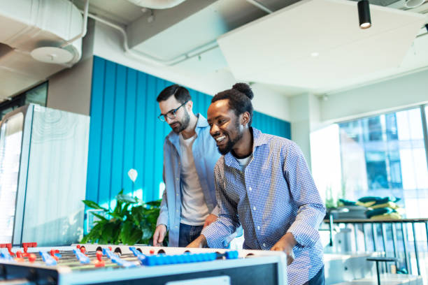 istock Colleagues relaxing in office playing foosball 2193308160
