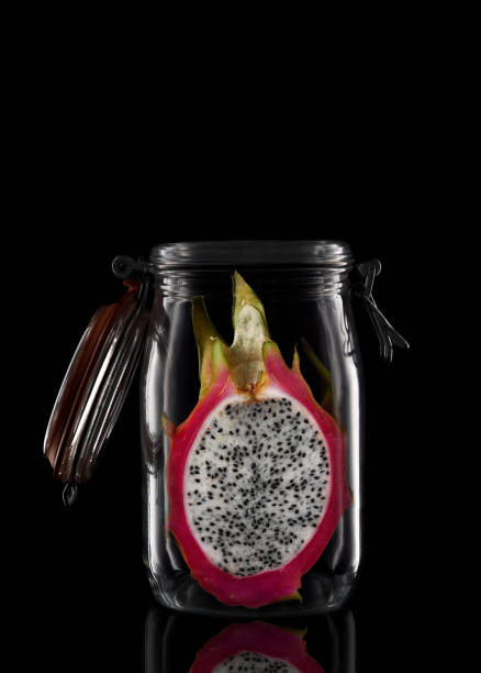 A glass storage or canning jar isolated on black with reflection, with lid open.