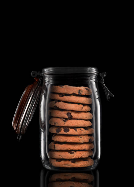 Chocolate chip cookies on wooden table. Still life or cookie jar and milk. Crunchy and tasty sweet food or dessert