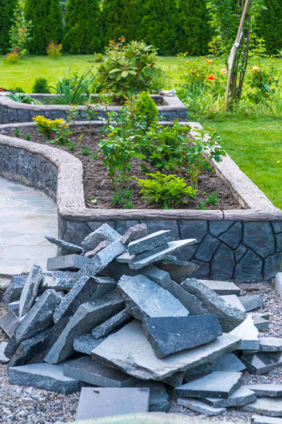 istock Decorative flowerbed with flowers and gray stones for construction. 2193309911
