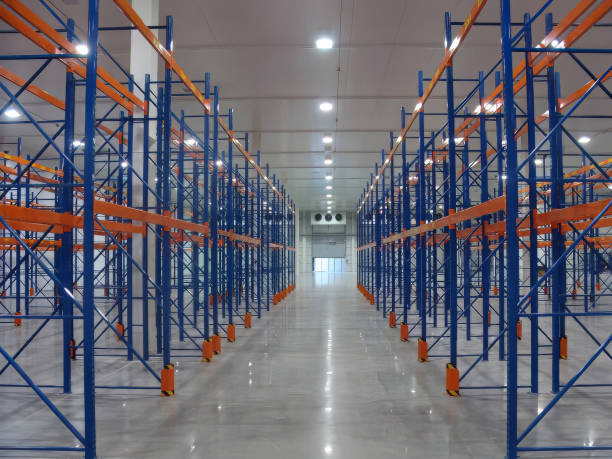 istock Organized cold storage warehouse with rows of assembled shelving units for product storage. 2193311574