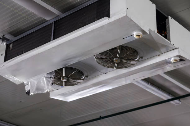 Industrial air cooler and ceiling-mounted refrigeration unit for temperature control in large spaces.
