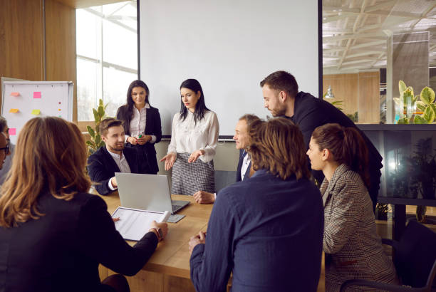 istock Colleagues discuss development strategy and financial results in office at corporate briefing. 2193315055