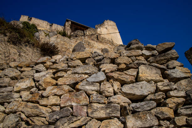 Stones texture of a medieval castle wall. Dry stone pattern of an ancient building made of rocks