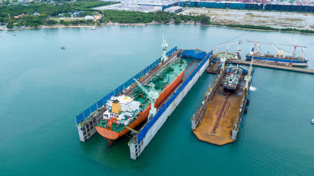 istock Tug boat Draging cargo container ship to dry dock concept maintenance service working in the sea. Insurance and Maintenance Cargo Ship concept. Freight Service maintenance Insurance 2193322904
