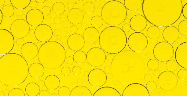 istock Macro microscope yellow bubble texture, Close-up Yellow bubbles and drops oil background . golden Yellow water bubbles, close up golden oil drop for celebration 2193323518