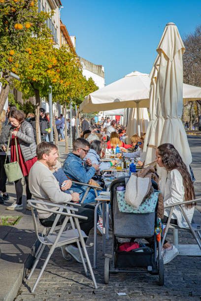 December, 2024. Cordoba, Spain. A restaurant street in the old town with various persons enjoying a sunny day.