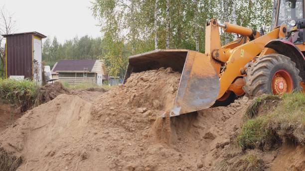 istock Yellow big excavator works with sand at construction site 2193323744