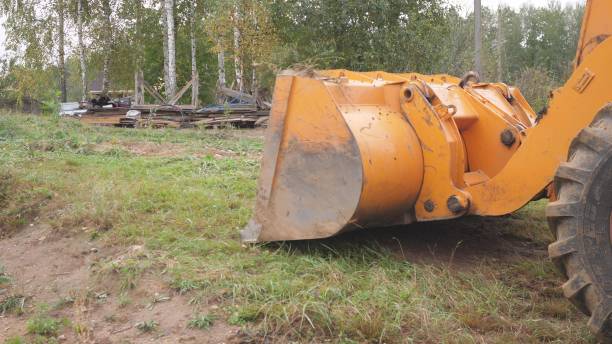 istock Yellow big excavator works with sand at construction site 2193323898