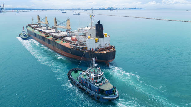 istock Cargo Ship was pulling by Tugboat go to Maintenance port. cargo ship import export to customers sea port. export shipping industry freight and transportation logistics concept 2193323934