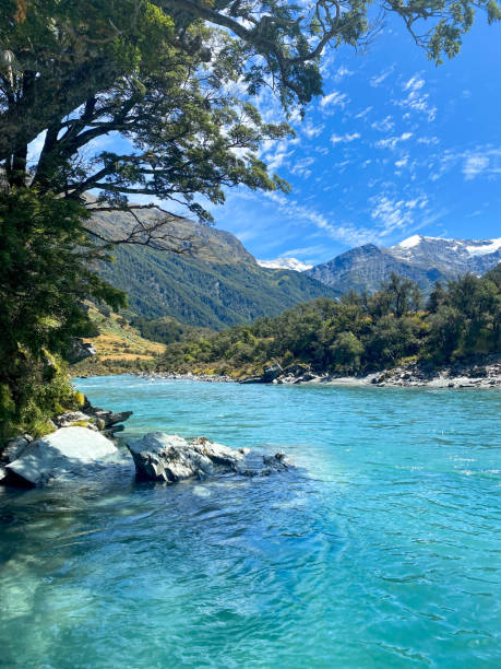 istock Glacial river with snow-capped mountains in background 2193324178