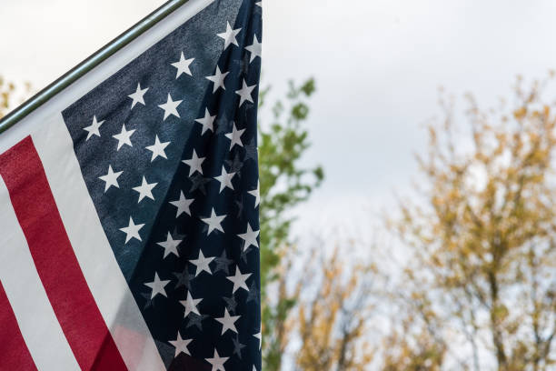 istock Hanging American Flag with Fall Foliage 2193324995