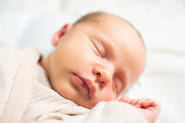 istock newborn baby, 23 days old, sleeping. 2193325322