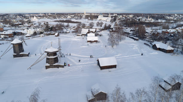 istock Snowy town with a few buildings and a windmill 2193327611