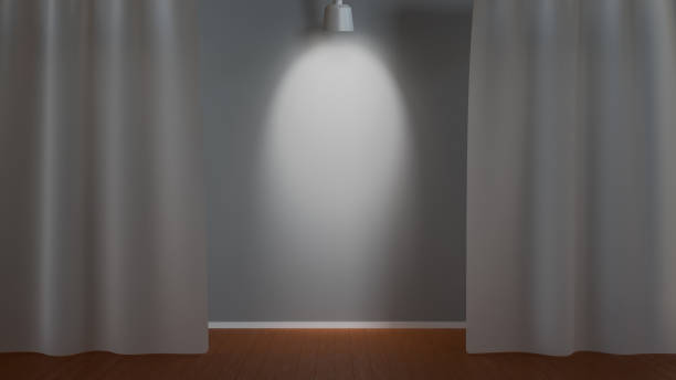 istock A spotlight illuminates a gray wall framed by parted white curtains 2193327666