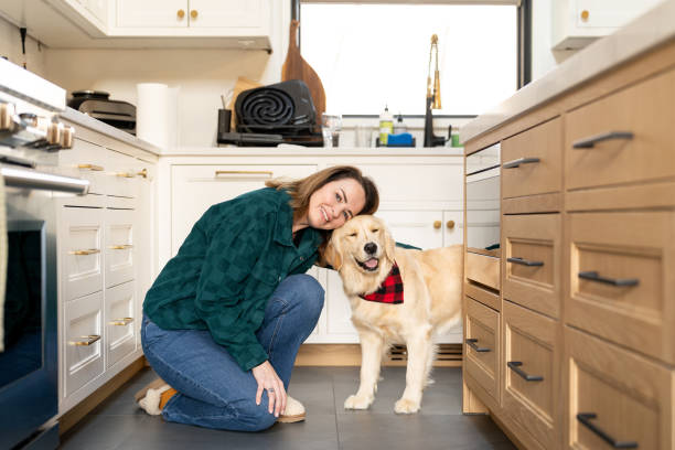 istock Woman with her dog in the kitchen 2193337441