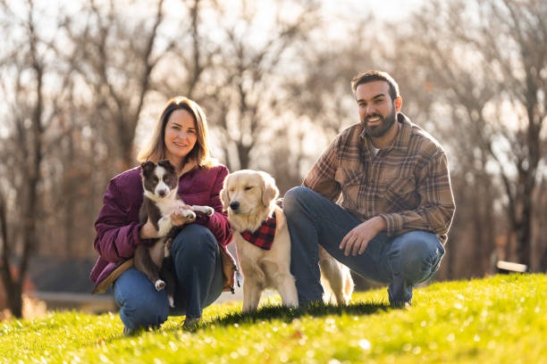 istock Couple outdoors with their dogs in a beautiful day 2193338676
