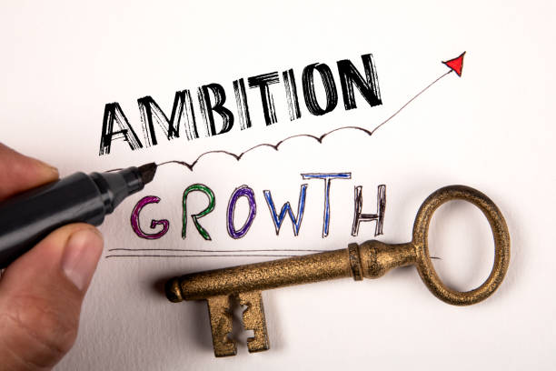 istock Ambition Concept. Text and gold-plated key on a white background 2193338821