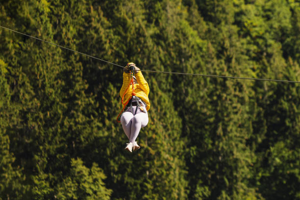 istock Female Adventure Enthusiast Enjoying Zipline Activity in Forest 2193341915