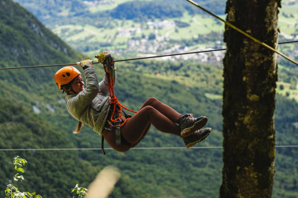 istock Female Adventurer on Zip Line Over Mountain Valley 2193341927