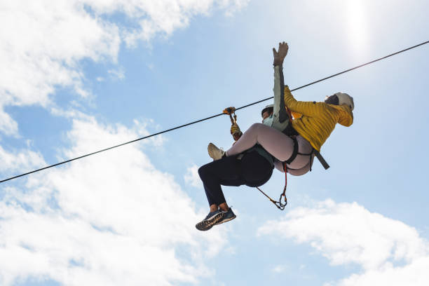 istock Female Adventure Seeker on Zipline Against Sky 2193341944