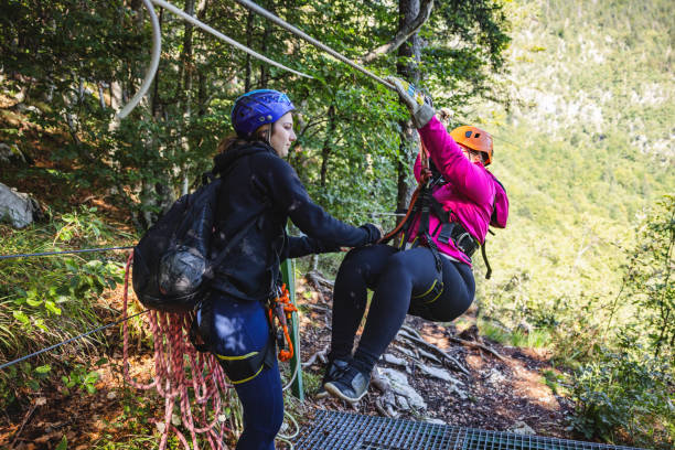 istock Zip Line Instructor Assisting Participant in Forest Adventure 2193342023