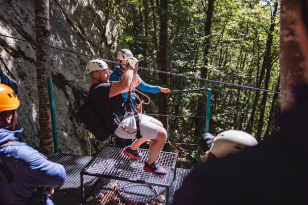 istock Tourists Preparing for Zip Line Adventure in Forest 2193342025