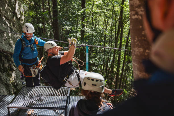istock Adventure Enthusiasts Preparing for Ziplining in Forest 2193342027
