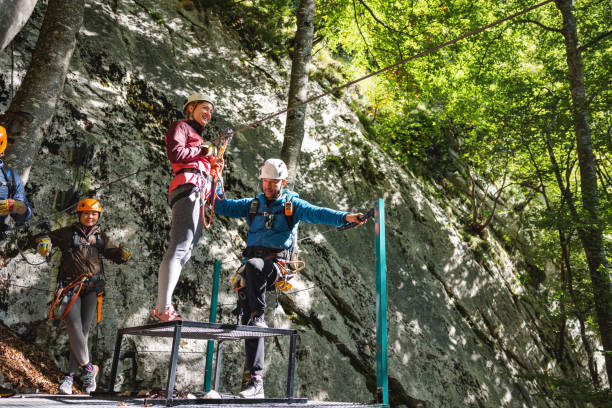 istock Group of People Preparing for Zip Line Adventure in Forest 2193342034