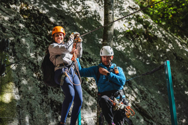 istock Couple Enjoying Zip Line Adventure in Forest 2193342044