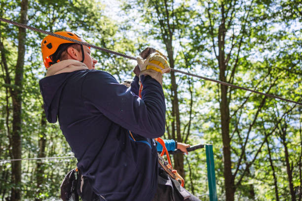 istock Man Preparing for Zip Line Adventure in Forest 2193342046