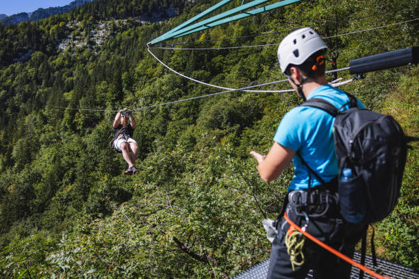 istock Adventurous Tourists Enjoying Zipline in Forest 2193342048