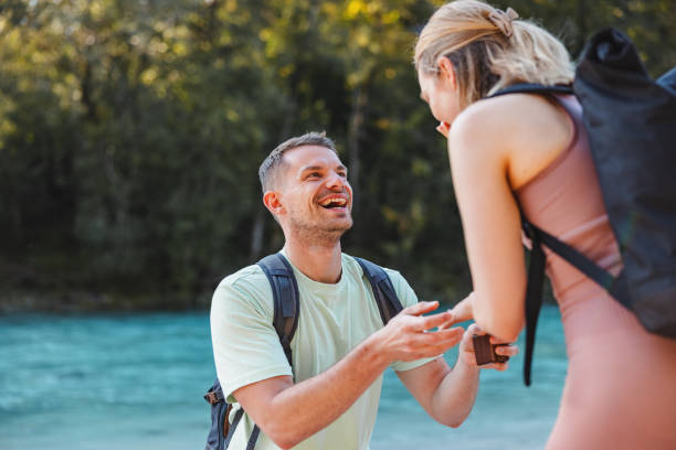 istock Man Proposing to Woman During a Hike by the River 2193342144