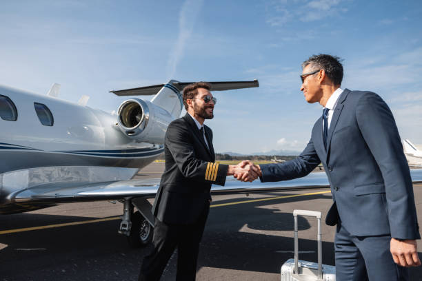 istock Pilot Greeting Business Executive at Private Jet 2193342300