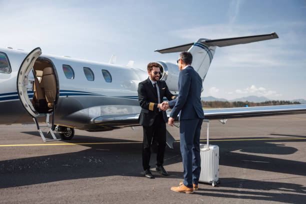 istock Pilot Greeting Businessman at Private Jet Before Boarding 2193342301