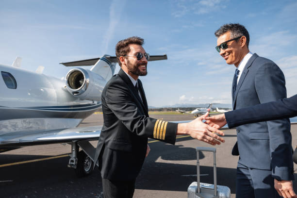 istock Businessmen Greeting By Private Jet On Sunny Day 2193342304