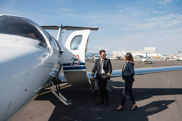 istock Businesswoman and Pilot Conversing by Private Jet 2193342305