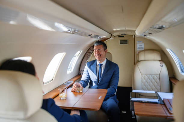 istock Two Executives Celebrating in Private Jet Cabin 2193342310