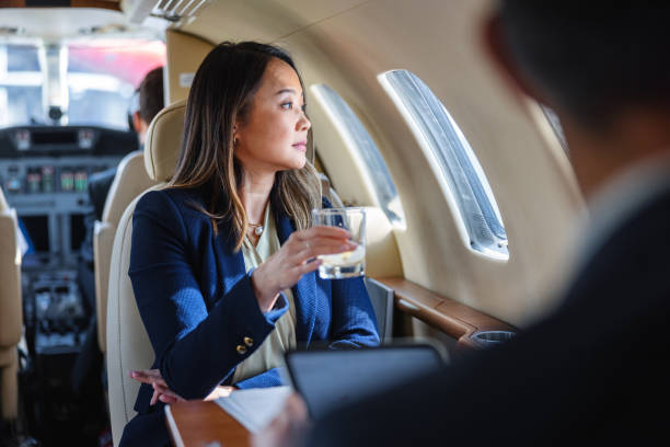 istock Executive Woman Drinking Whiskey on Private Jet 2193342319