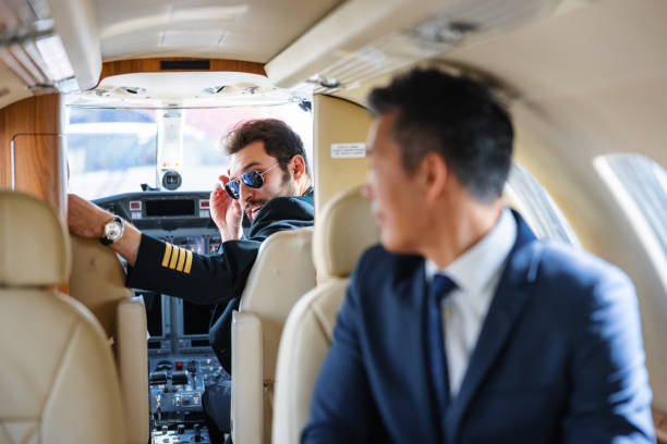 istock Hispanic Pilot Discussing Flight Details with Businessman on Private Jet 2193342321