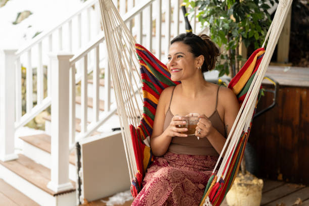 istock Latin woman drinking tea outside her house 2193348232