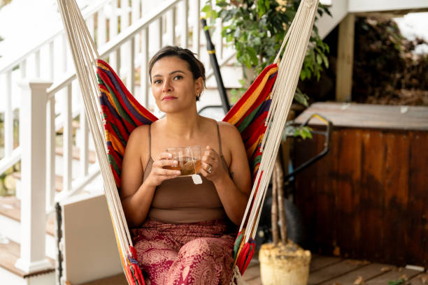 istock Latin woman drinking tea outside her house 2193348234